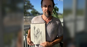An artist holding the original Isla sketch